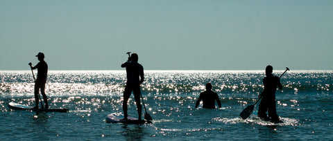 men paddling on the water