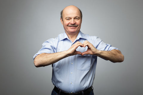 old man making heart sign