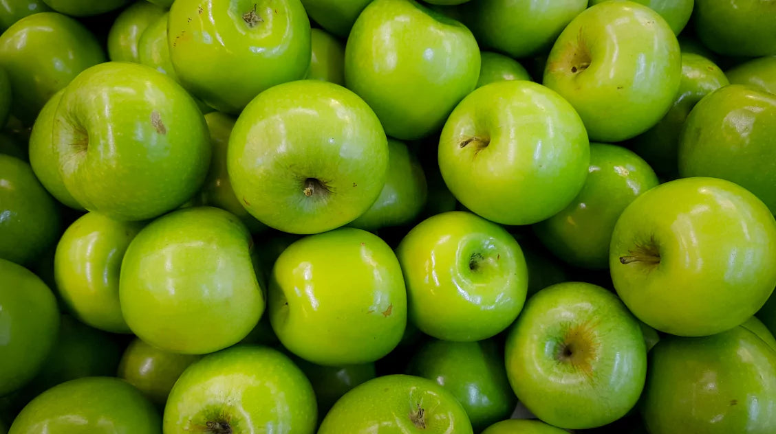 A pile of fresh, green apples.