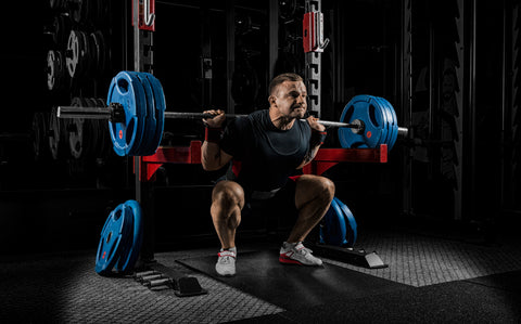 man performing barbell squat