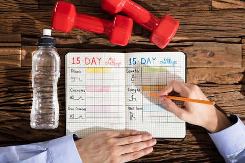 man writing in training log