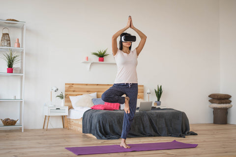 woman working out with VR headset in bedroom