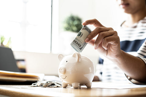 woman saving money in piggy bank