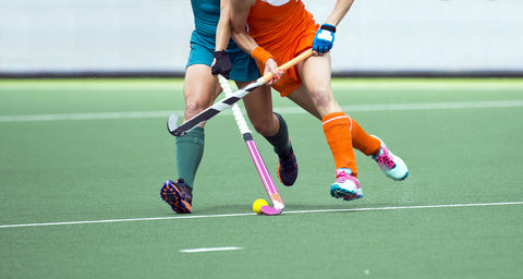 women playing field hockey