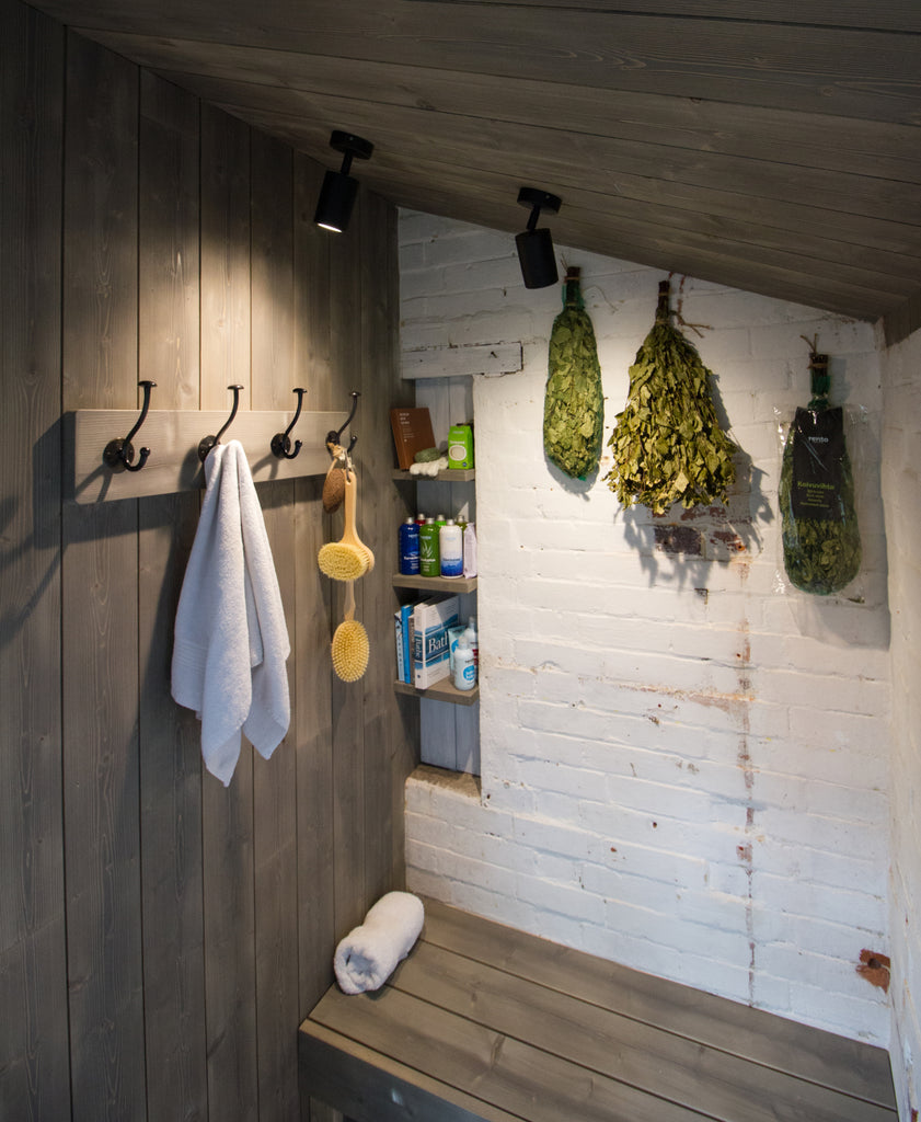 Hooks were added to the side of the saunas entrance, and a single alcove shelf unit nestled within the far wall, against the front of the sauna.