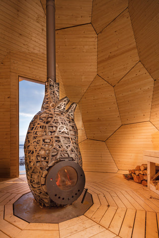 Wood fired sauna stove inside the golden egg sauna