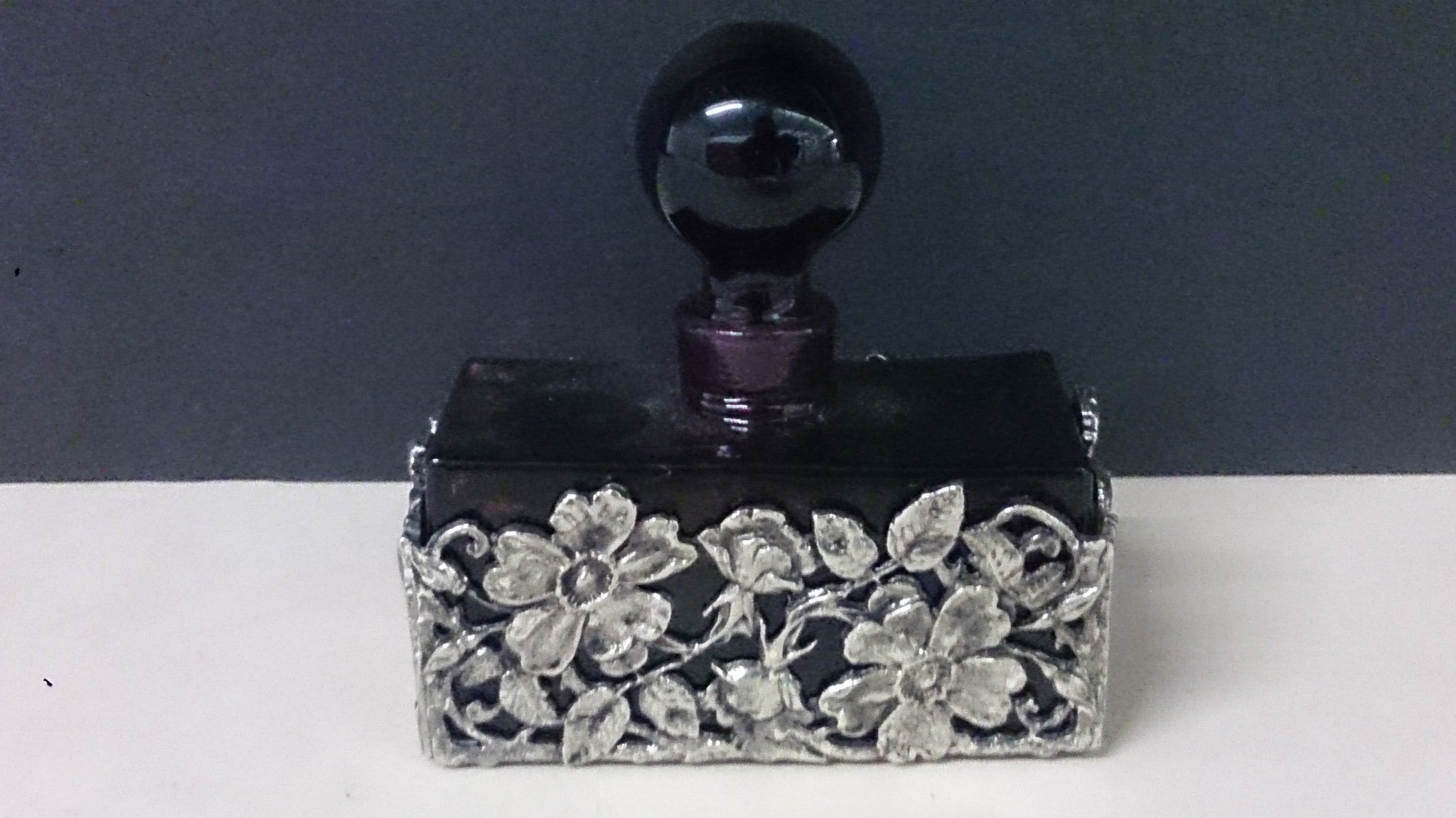 dark purple perfume bottle