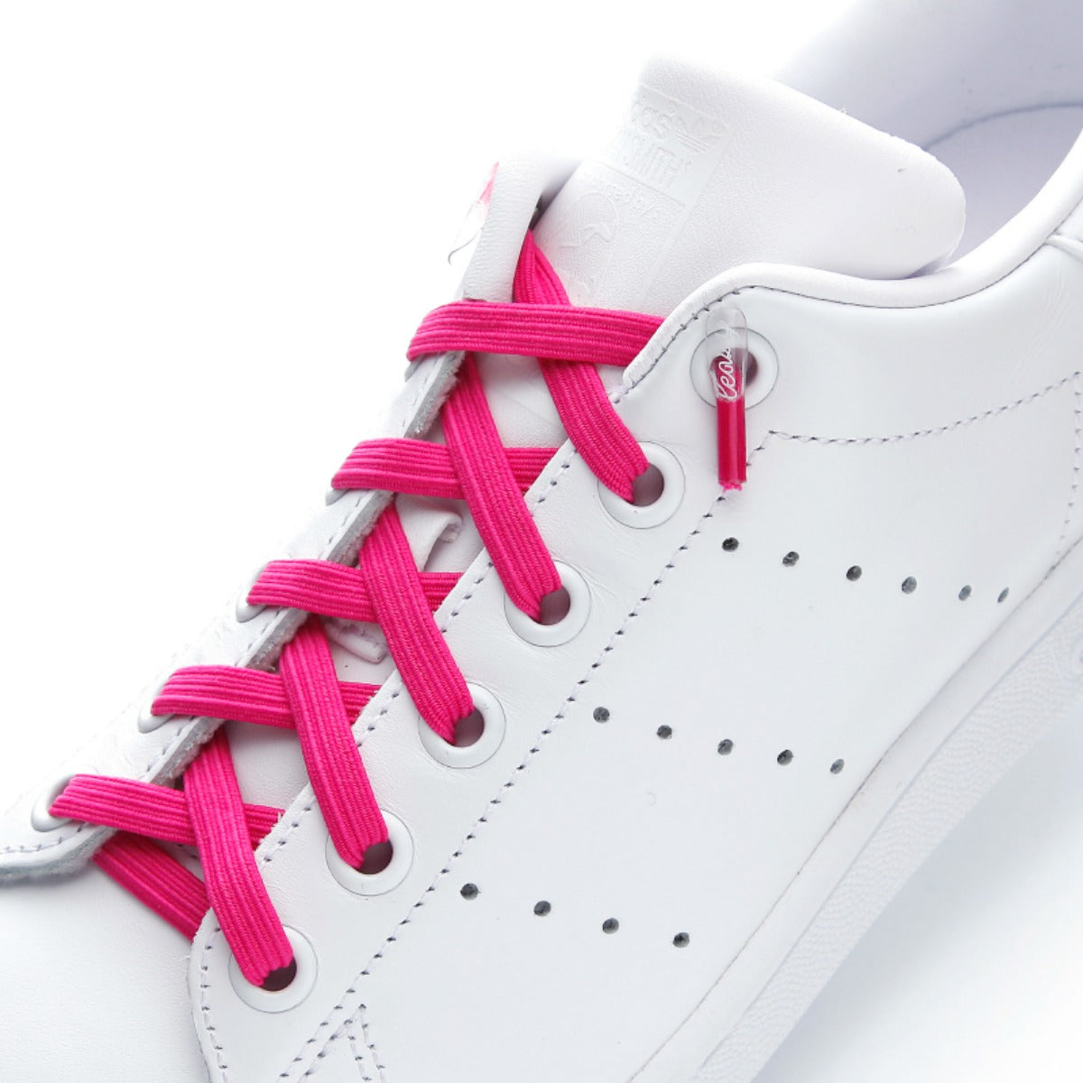 white shoes with pink shoelaces