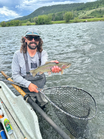 MRO Guide Jake Schilling netting a nice Madison River rainbow