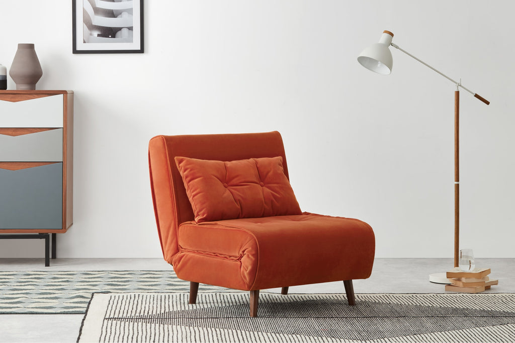A stylish sofa bed in a modern, minimal room