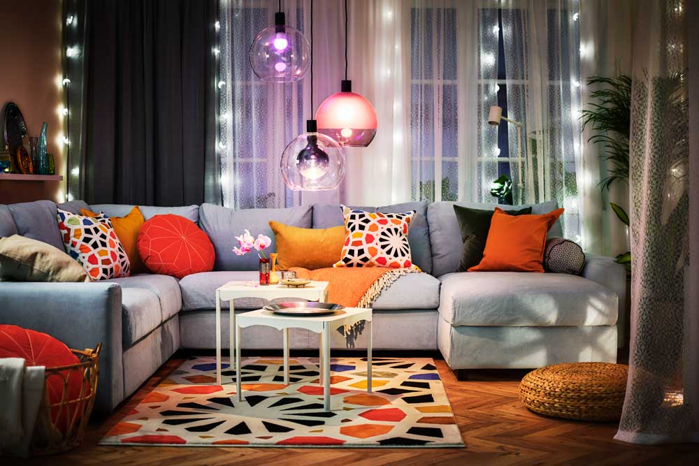 A colorfully-decorated and lit lounge space with a corner sofa.