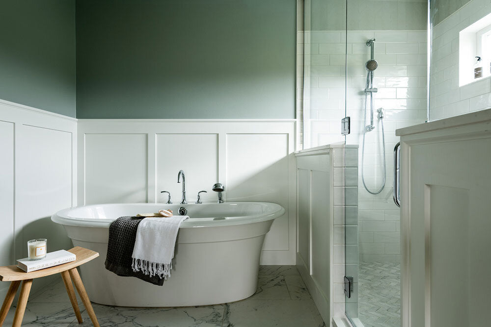 A green-painted bathroom decorated in the transitional style