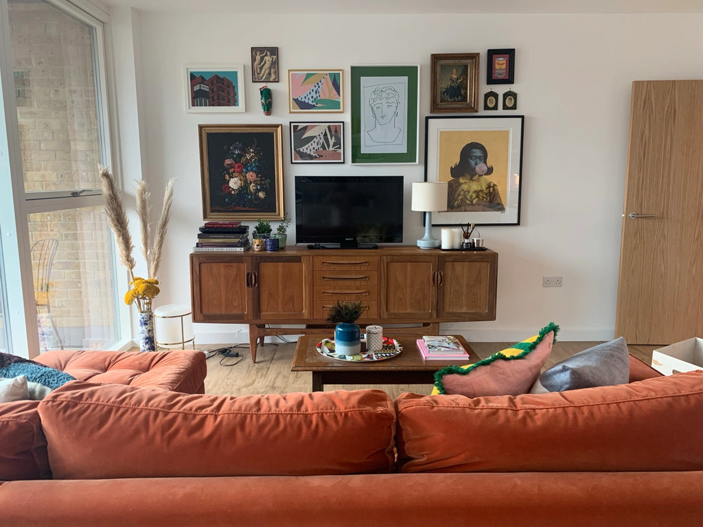 A cozy lounge with a “gallery wall” of artworks