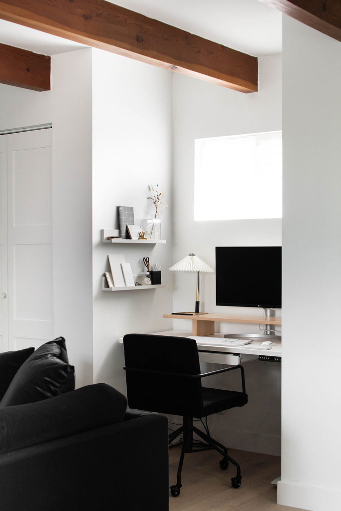 A minimal, modern space with an office nook with desk, computer, and chair