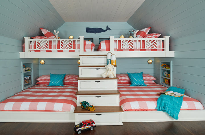 A children’s bedroom with beds, sofa, and colorful accents, with turquoise walls