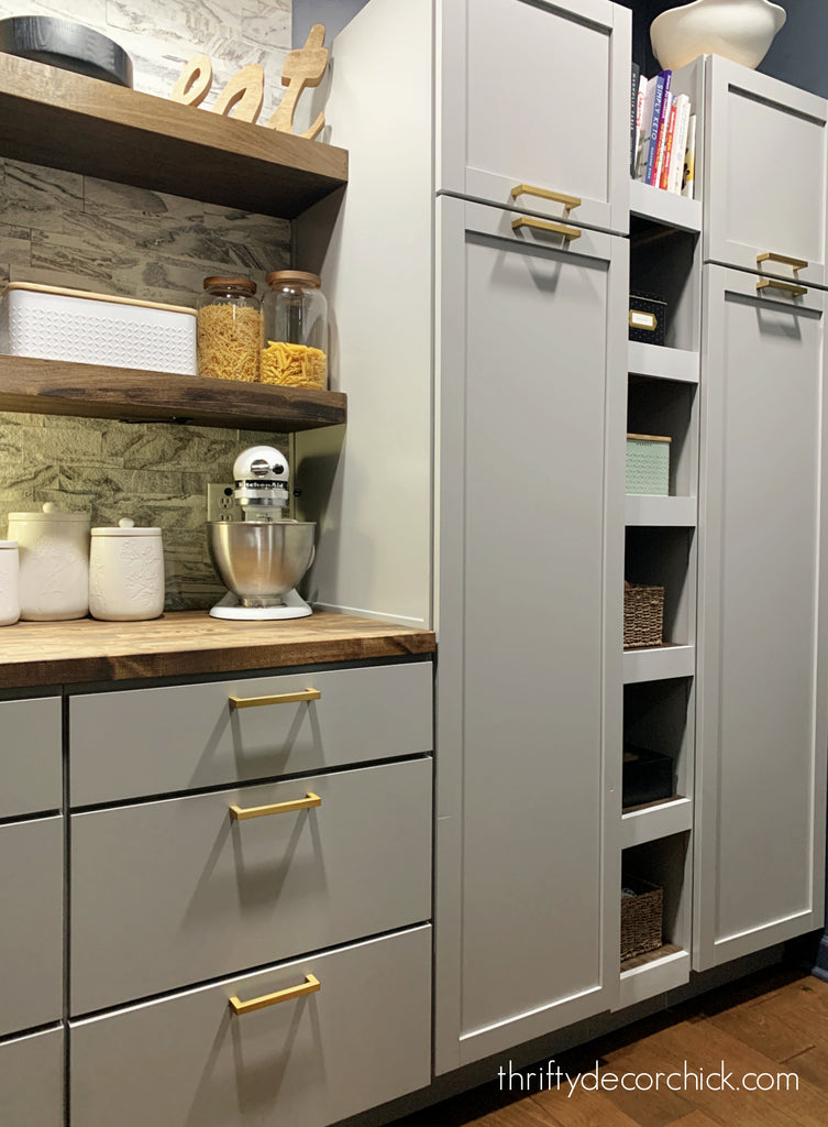 Modern kitchen units with wooden shelves and wicker storage baskets