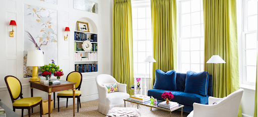A colorfully-decorated room with chairs, tables, and a shelving alcove