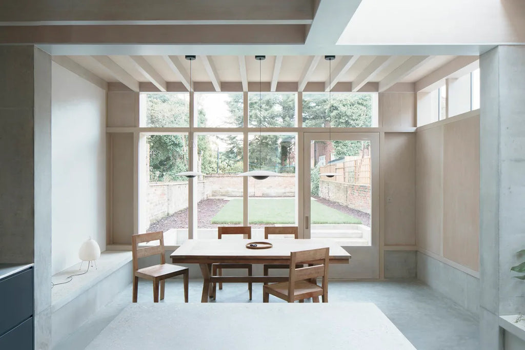 A large, minimal, naturally-lit dining area