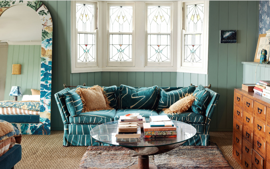 A colorful room with blue and green tones, with a sofa and coffee table