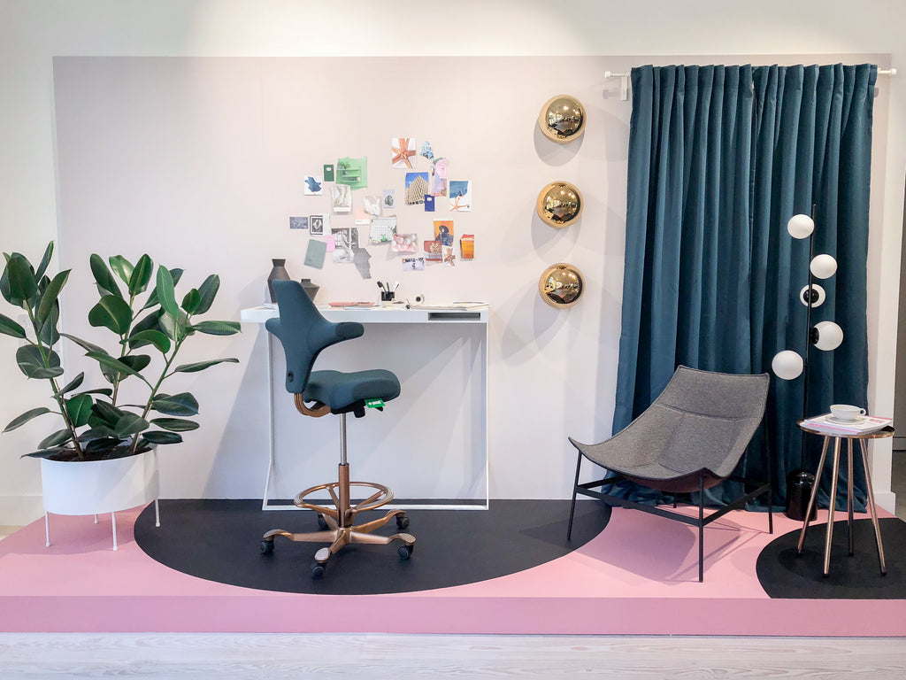 A colorful, modern home office with chairs, desk, and decorative houseplant