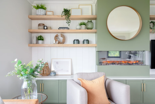 A room decorated with alcove fireplace unit, shelves, and houseplants