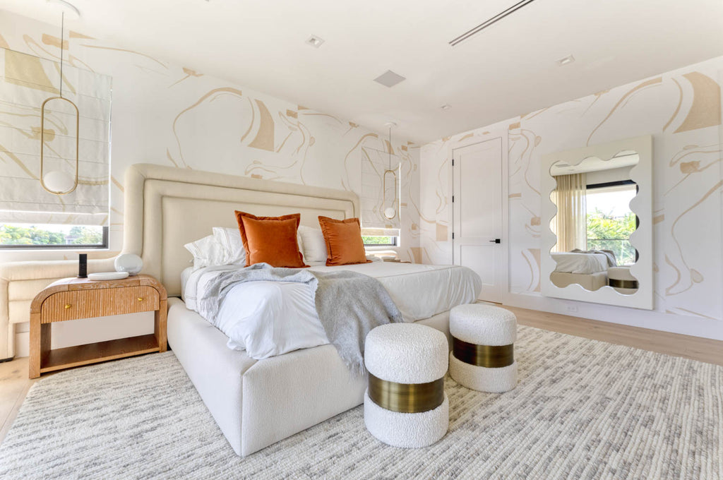 A spacious, brightly-lit bedroom decorated in the transitional style