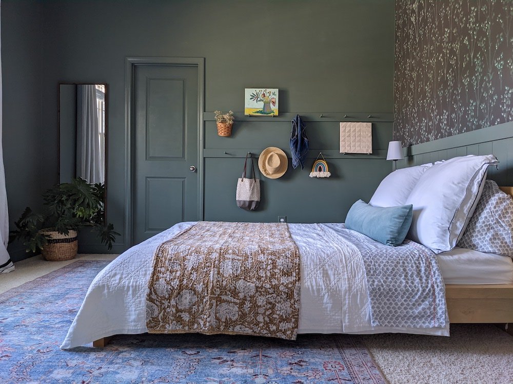 A bedroom decorated in a green tone