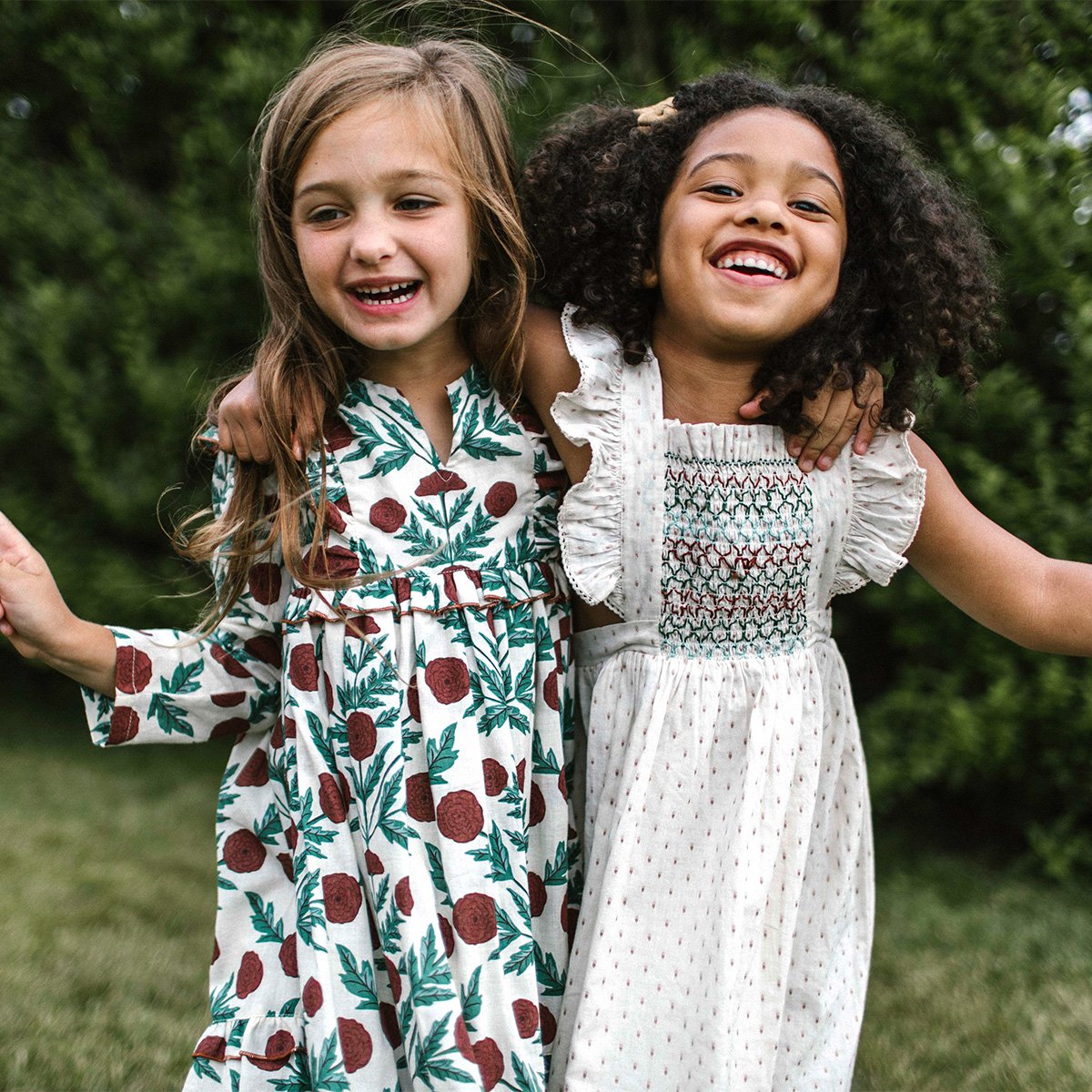 Two happy girls wearing Pink Chicken dresses