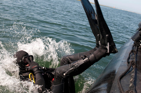 Diver back rolling into water