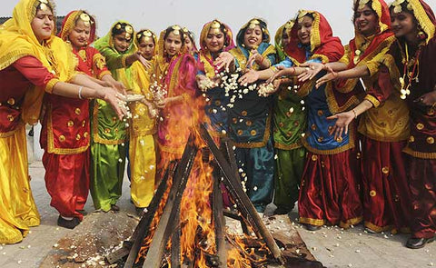 Women offering popcorn, rewari, sesame seeds to the Lohri