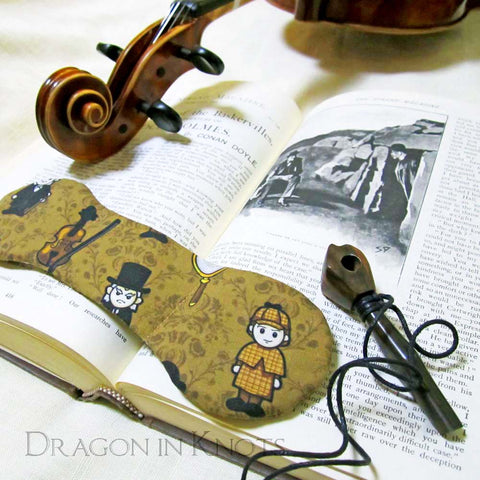 Sherlock Holmes book weight on vintage book with viola and pipe