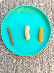 Kizingo tasting plate with pretzel, veggie puff, and baby carrot