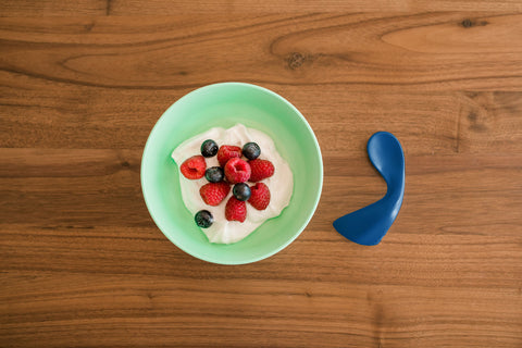 bowl of yogurt and fruit sitting on a table