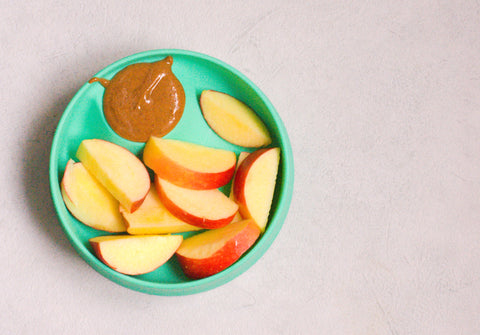 bowl of apple slices with nut butter