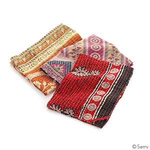 kantha dish towels in warm colors on a white background