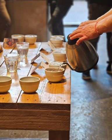 Cupping bowls being filled with water.
