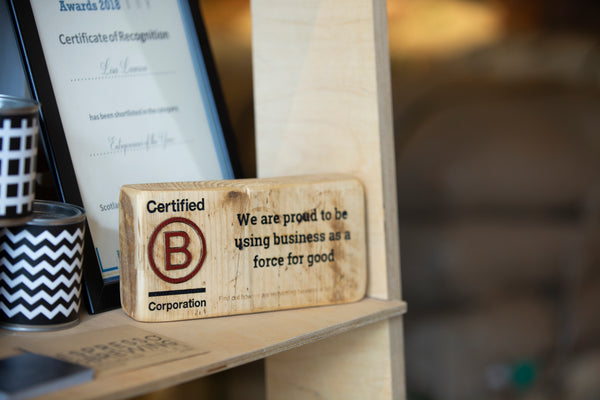 Wooden display showing our B Corp certification.