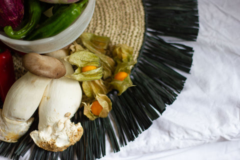 fresh produce on a handwoven placemat