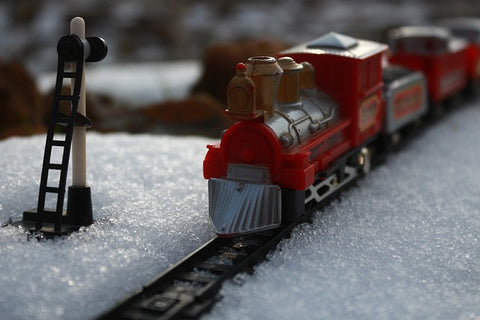 A Christmas model train in a fake snow layout