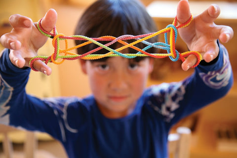 A child plays with a string game