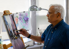 Artist painting a a watercolor at an easel