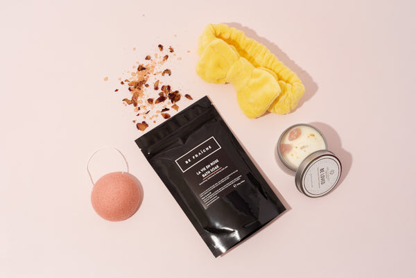 Be Fraiche Rose bath salts in luxury black packaging with rose quartz crystal candle, pink konjac sponge and yellow headband