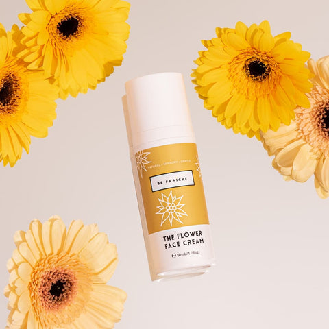 Be Fraiche Flower Face Cream flat lay, styled with yellow flowers