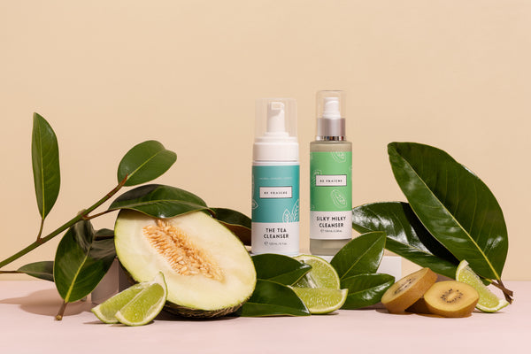 Styled image of Be Fraiche Tea Cleanser and Silky Milky Cleanser surrounding with cucumber, melons and green tea leaves