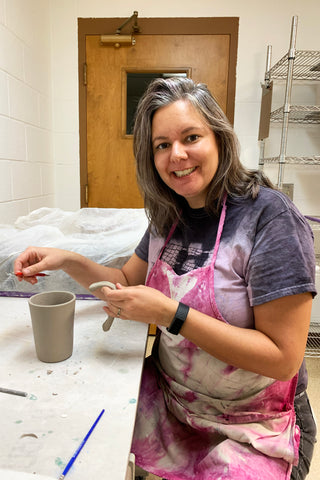 Heidi Fahrenbacher putting handles on a mug