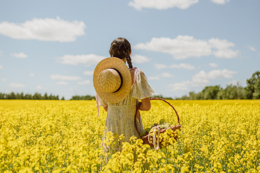 Woman standing in the middle of a field of flowers