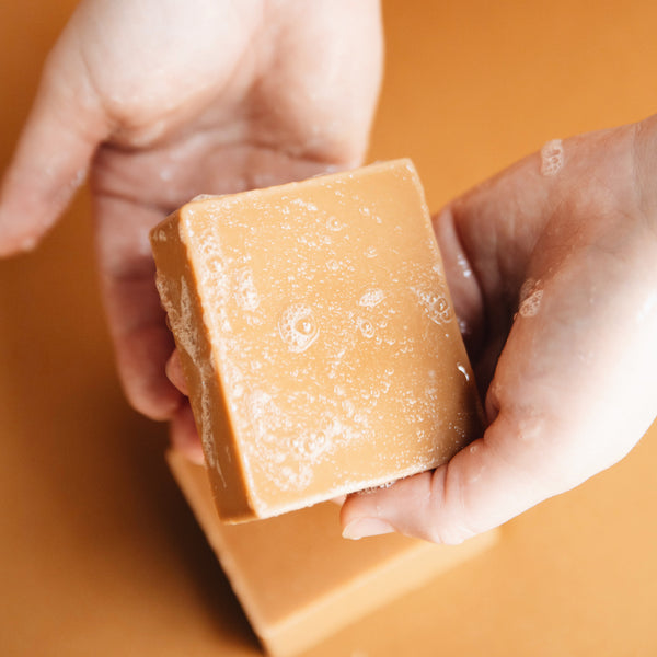 An image of someone washing their hands with bar soap