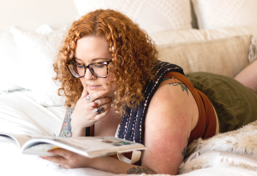 Woman laying in bed with a therapeutic neck wrap on