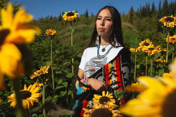 Quannah Chasinghorse in a field of sunflowers