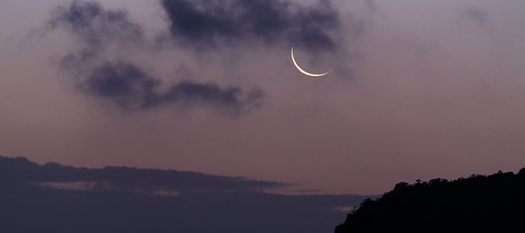 Waning Crescent Moon Phase glowing in the Dusk Sky